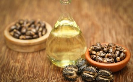 Castor beans and oil in a glass jar